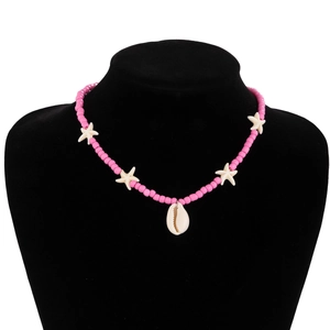 Detailed close-up of pink beaded bohemian necklace with starfish and shell charms