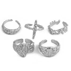 Detail of silver lava texture ring set with irregular wave patterns and cross design
