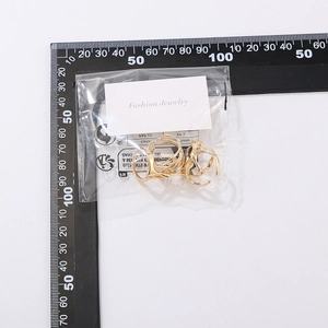 Detailed view of irregular lava style gold ring set on fashion jewelry display card