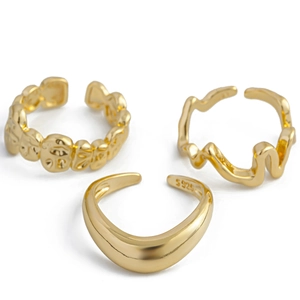 Detail of S925 stamped gold geometric rings set with irregular wave and lava textures