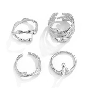 Detail of four irregular silver lava rings with liquid flow and minimalist open design