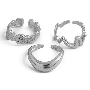 Macro detail of silver S925 stamped rings with lava texture and minimalist wave design