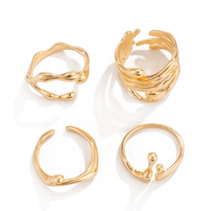 Detailed view of four organic molten liquid style gold rings with irregular shapes