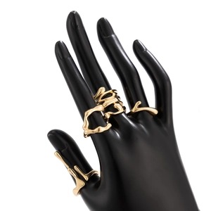 Detail shot of irregular golden lava ring showing artistic branch structure and smooth finish