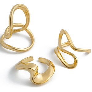 Detail view of 3pcs gold irregular lava rings with minimalist polished fluid design