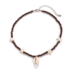 Beaded necklace with seashells and starfish charms on white background for beach style