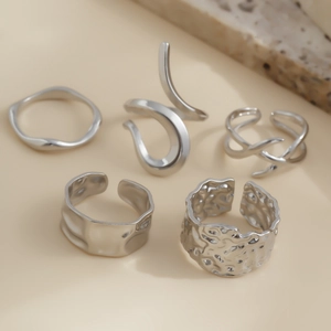Set of 5 silver geometric lava rings with irregular textures and adjustable open bands