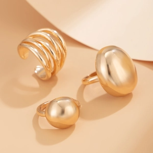 Detailed view of irregular molten texture gold ring set with multi-layer line designs