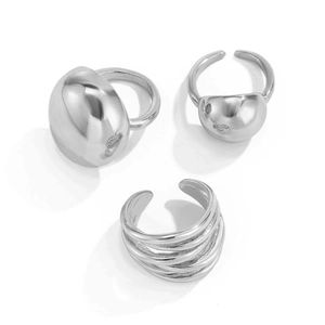 Three-piece set of polished silver lava rings featuring smooth domed and layered wrap designs