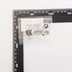 Silver bow ring measurement showing a 12mm diameter next to a black metric ruler