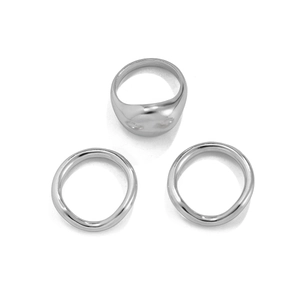 Detailed view of three silver lava rings with irregular organic textures and polished finish