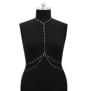 Detail of multi-layer silver body chain with star pendants on a black mannequin