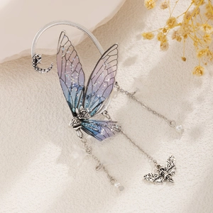 Detail of silver butterfly ear cuff with blue-purple gradient wings and pearl tassels