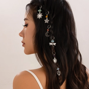 Bohemian silver alloy dreadlock charms with sun, moon and star pendants on braided hair