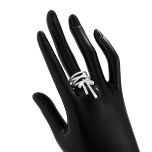 Silver bow ring with multi-layer wrap design displayed on a black hand model