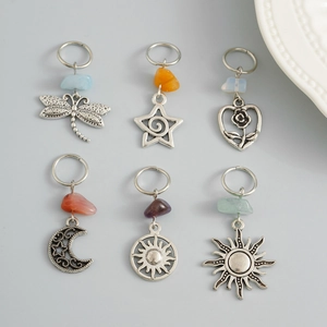 Detail view of retro alloy hair braid rings with natural stones and sun dragonfly charms