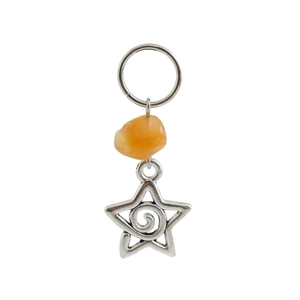Detail of silver alloy star charm with orange gemstone for boho hair braid styling