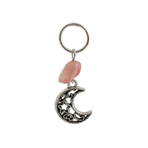 Close-up of alloy braid ring with pink stone and hollow moon star charm pendant