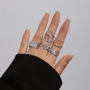 5-piece silver geometric lava texture ring set with irregular metallic lines on hand