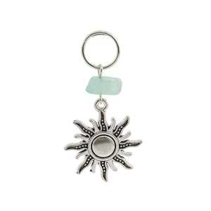 Detail of sun totem pendant in antique silver finish with light blue natural stone