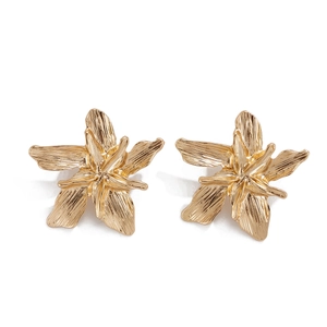 Detailed view of champagne gold lily earrings featuring refined vertical brushed metal texture