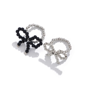 Minimalist beaded bow rings in black and silver metallic finishes with a unique open design