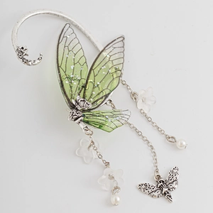 Silver elf ear cuff with green butterfly wings and floral tassel on white backdrop