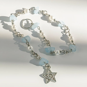 Dettaglio della catena d'argento con pietre azzurre, perle e ciondolo a stella