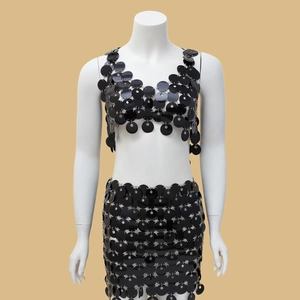 Detail of black sequin crop top and mini skirt set with silver metal ring connectors