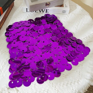Detail of purple sequin body chain with large round disks and metallic rings