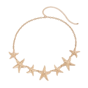 Detail of golden starfish body chain featuring seven textured charms and lobster clasp