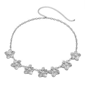 Detailed view of silver body chain featuring metal flowers with pearls and lobster clasp
