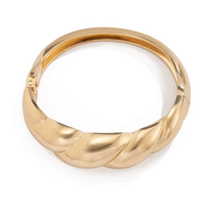 Golden chunky water drop bangle with mirror finish and bold twisted metal design