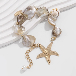 Detailed macro of ocean-themed bracelet with natural shells, starfish charm and pearls
