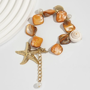 Detail of beach style bracelet featuring orange shell pieces, white pearls and starfish charm