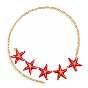 Detail of gold body chain featuring five vibrant red starfish charms and lobster clasp