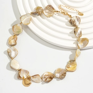 Detail of natural seashell fragments necklace with golden shell pendant and lobster clasp