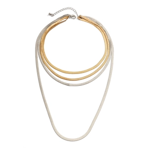 Detail of layered gold and silver snake bone necklaces with lobster clasp and adjuster