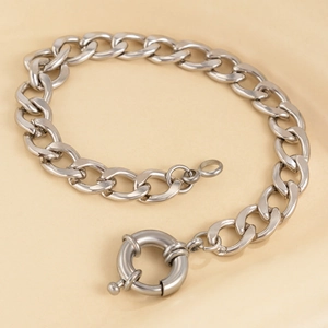 Detail of silver chunky Cuban link bracelet with large circular mariner spring clasp