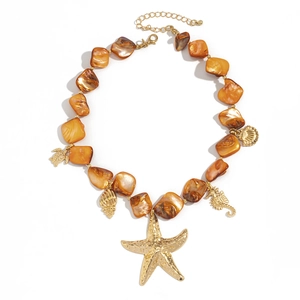 Detail of shell necklace with golden starfish seahorse and turtle charms on white background
