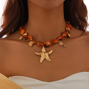 Detailed view of beaded ocean necklace with gold starfish, seahorse and turtle charms
