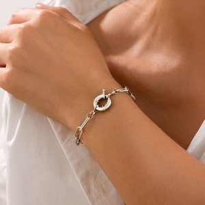 Close-up of a silver-toned geometric chunky chain bracelet with a large spring clasp buckle