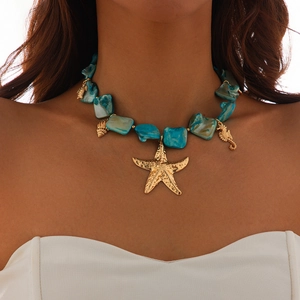 Close-up of ocean style starfish and shell pendants on a turquoise bead necklace