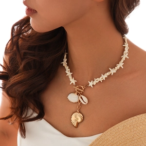 Detail of beach ocean style necklace with white starfish beads and shell pendants