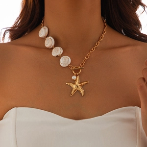Close-up of ocean-style necklace with gold starfish, pearl, and white seashells