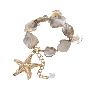 Shell and starfish charm bracelet with pearls and golden marine pendants on white backdrop