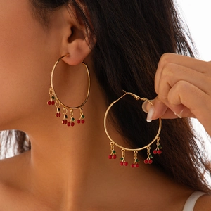 Bohemian gold hoop earrings featuring five vibrant red cherry pendants with green leaves