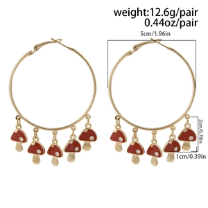 Detailed view of large gold hoop earrings with red mushroom charms and size measurements