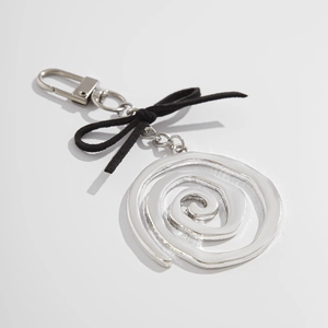 Détail d'un pendentif spirale argenté avec nœud en daim noir et fermoir mousqueton
