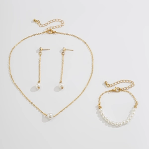 Ensemble détaillé de collier, boucles d'oreilles et bracelet dorés avec perles blanches
